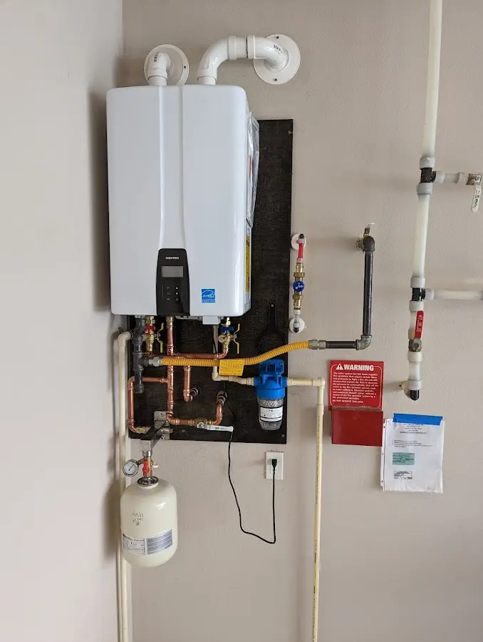 Professional plumber installing copper piping in a Berkeley home